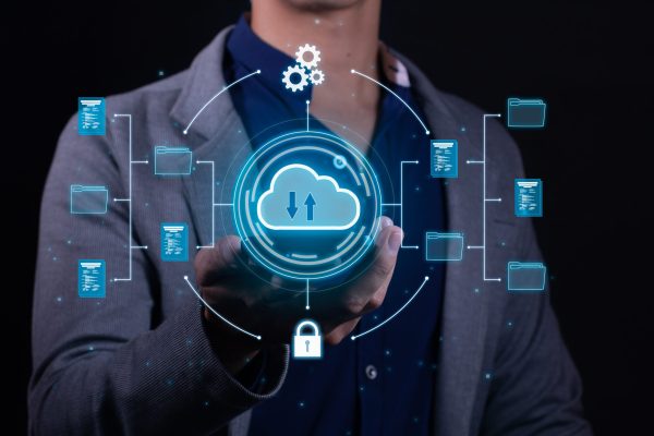 A man employs cloud-based computing on his smartphone to facilitate data transmission, storage, backup, and access A man employs cloud-based computing on his smartphone to facilitate data transmission, storage, backup, and access