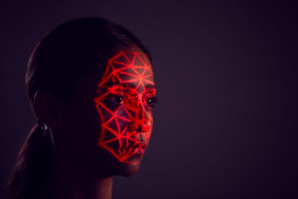 Facial Recognition Technology Concept As Woman Has Red Grid Projected Onto Face In Studio Facial Recognition Technology Concept As Woman Has Red Grid Projected Onto Face In Studio